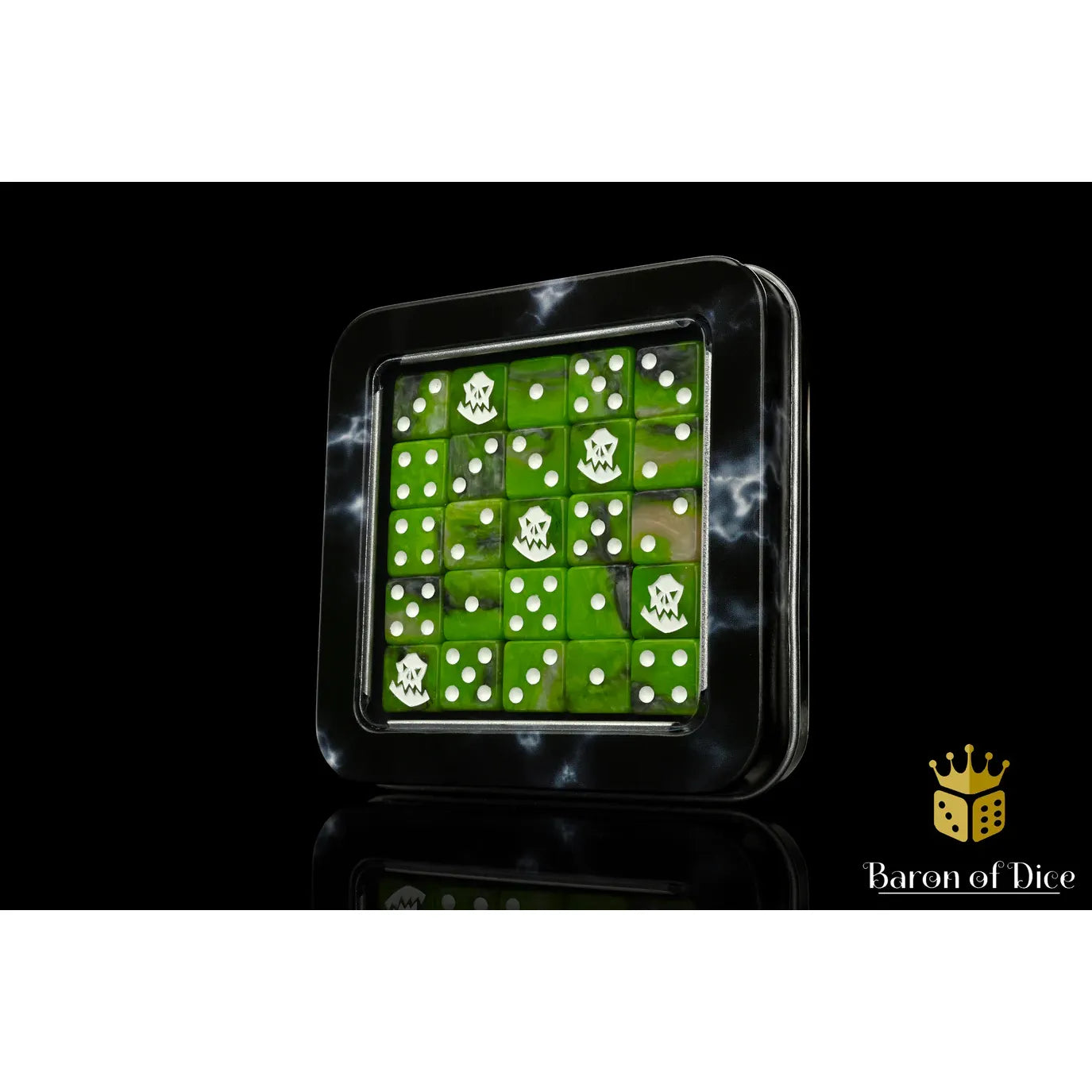 A square black game box with a clear lid displaying a grid of green dice, each marked with a white skull icon. The box is photographed on a black reflective surface with a faint reflection below.